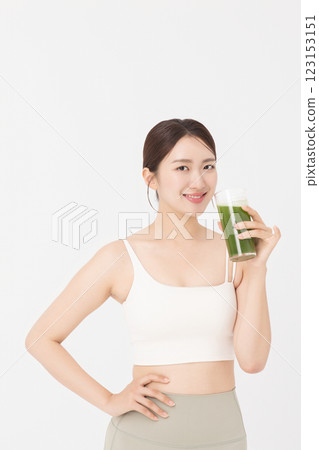 Cropped view of young woman wearing sportswear and drinking healthy drink Cropped view of young woman wearing sportswear and drinking healthy drink 123153151