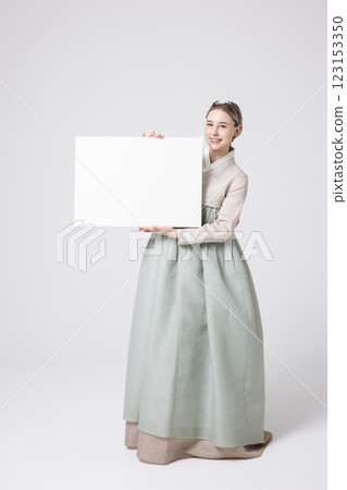 Portrait of a Western woman wearing Hanbok and standing with copyspace Portrait of a Western woman wearing Hanbok and standing with copyspace 123153350