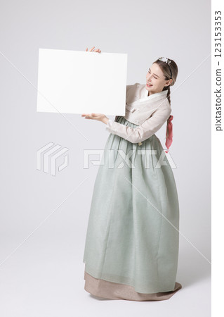 Portrait of a Western woman wearing Hanbok and standing with copyspace Portrait of a Western woman wearing Hanbok and standing with copyspace 123153353