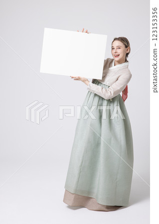 Portrait of a Western woman wearing Hanbok and standing with copyspace Portrait of a Western woman wearing Hanbok and standing with copyspace 123153356