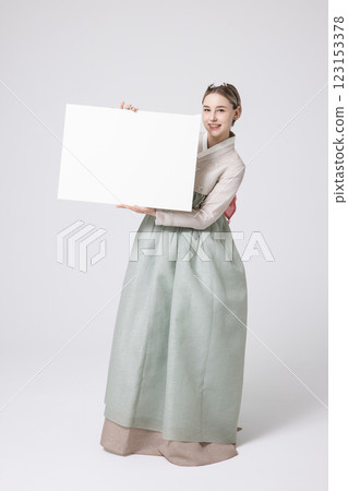 Portrait of a Western woman wearing Hanbok and standing with copyspace Portrait of a Western woman wearing Hanbok and standing with copyspace 123153378