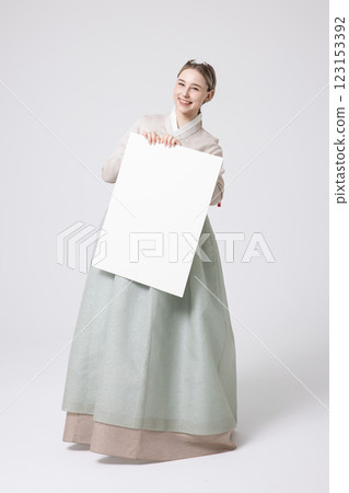 Portrait of a Western woman wearing Hanbok and standing with copyspace Portrait of a Western woman wearing Hanbok and standing with copyspace 123153392