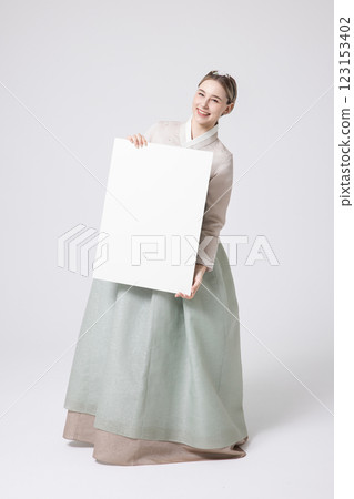 Portrait of a Western woman wearing Hanbok and standing with copyspace 123153402