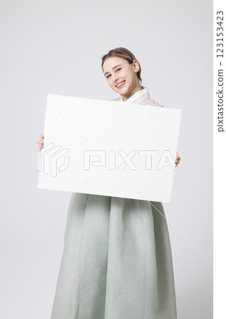 Portrait of a Western woman wearing Hanbok and standing with copyspace Portrait of a Western woman wearing Hanbok and standing with copyspace 123153423