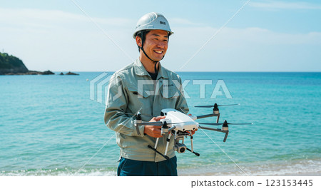 Man with drone on the beach 123153445