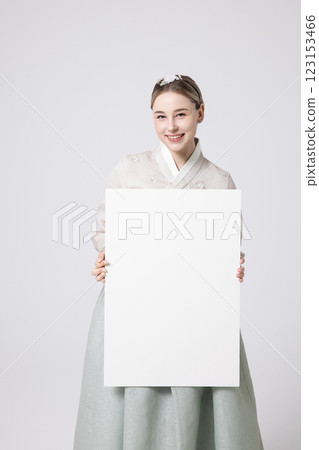 Portrait of a Western woman wearing Hanbok and standing with copyspace Portrait of a Western woman wearing Hanbok and standing with copyspace 123153466