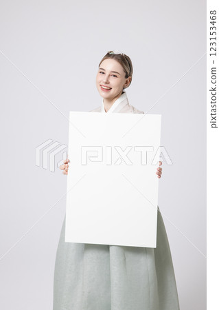 Portrait of a Western woman wearing Hanbok and standing with copyspace Portrait of a Western woman wearing Hanbok and standing with copyspace 123153468