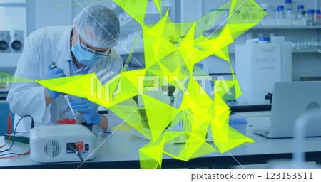 Image of glowing light trails over diverse scientists in laboratory 123153511