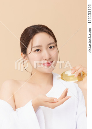 Portrait of beautiful young woman posing with oil Portrait of beautiful young woman posing with oil 123153593