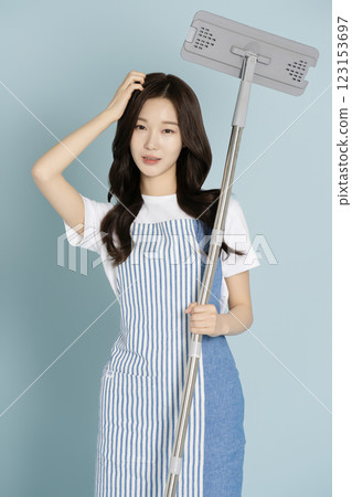 A woman in her 20s holding a gunny mop A woman in her 20s holding a gunny mop 123153697