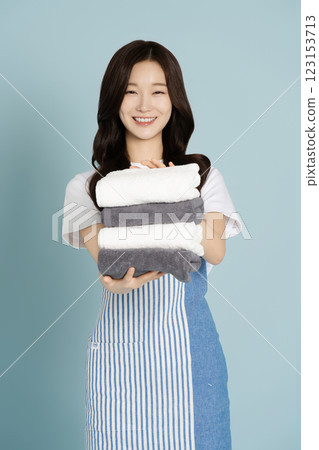 A woman in her 20s carrying a towel A woman in her 20s carrying a towel 123153713