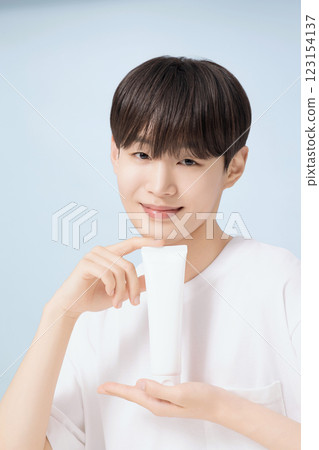 A young man demonstrating basic men's cosmetics A young man demonstrating basic men's cosmetics 123154137