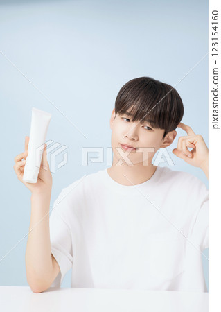 A young man demonstrating basic men's cosmetics 123154160
