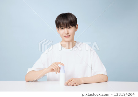 A young man demonstrating basic men's cosmetics 123154204