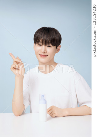 A young man demonstrating basic men's cosmetics A young man demonstrating basic men's cosmetics 123154230