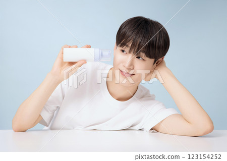 A young man demonstrating basic men's cosmetics 123154252