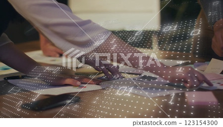 Image of binary coding over diverse colleagues discussing project 123154300