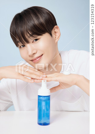 A young man demonstrating basic men's cosmetics A young man demonstrating basic men's cosmetics 123154319