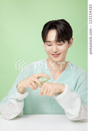 A man in his 20s posing with green essence 123154383