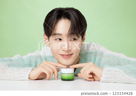 A man in his 20s posing with green essence A man in his 20s posing with green essence 123154426