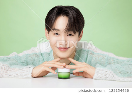 A man in his 20s posing with green essence 123154436