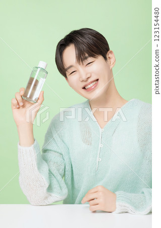 A man in his 20s posing with green essence 123154480