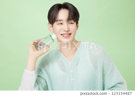 A man in his 20s posing with green essence 123154487