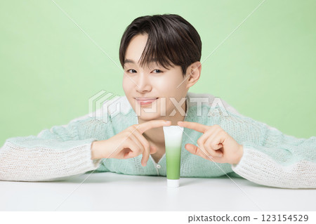 A man in his 20s posing with green essence 123154529