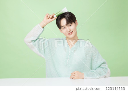 A man in his 20s posing with green essence 123154533