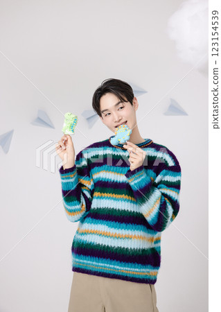 Portrait of man holding dinosaur candy in clouds 123154539