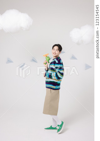 Cropped view of man standing in clouds holding toy bubble gun 123154545