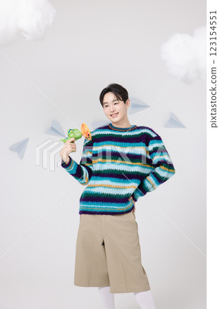 Cropped view of man standing in clouds holding toy bubble gun 123154551