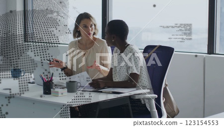Image of data processing and globe over diverse female colleagues discussing work in office Image of data processing and globe over diverse female colleagues discussing work in office 123154553
