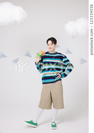 Cropped view of man standing in clouds holding toy bubble gun 123154556