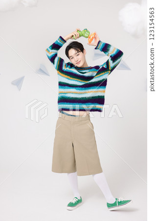 Cropped view of man standing in clouds holding toy bubble gun 123154563