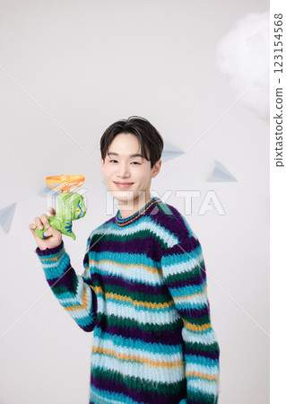 Cropped view of man standing in clouds holding toy bubble gun 123154568