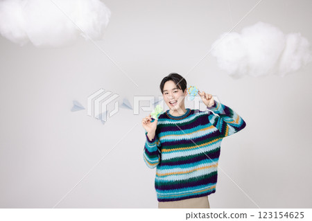 Portrait of a man standing in the clouds holding candy Portrait of a man standing in the clouds holding candy 123154625