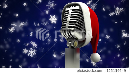 Image of snow falling over microphone with santa hat 123154649
