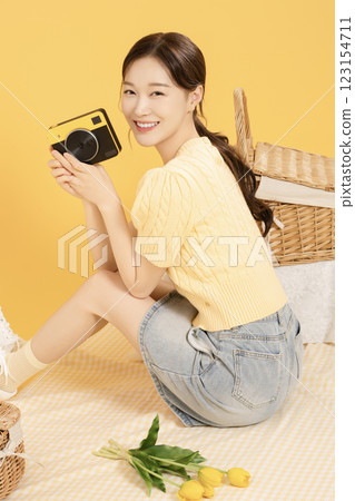 A woman in her 20s spreading out a mat and enjoying a picnic A woman in her 20s spreading out a mat and enjoying a picnic 123154711