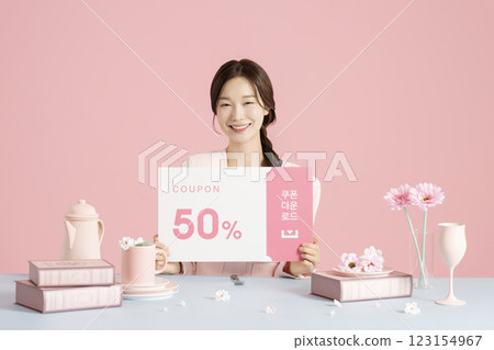A woman in her 20s holding a coupon A woman in her 20s holding a coupon 123154967