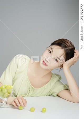 A woman in her 20s posing in front of a glass of Shine Musket 123155272