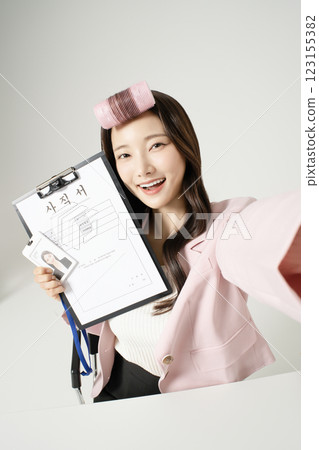 MZ employee taking a selfie holding a resignation letter MZ employee taking a selfie holding a resignation letter 123155382