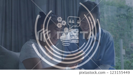 Image of business icons over asian female doctor and patient 123155449