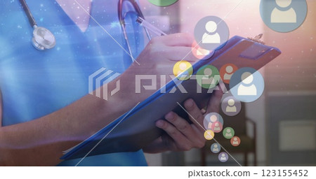 Image of social media icons over caucasian female doctor taking notes Image of social media icons over caucasian female doctor taking notes 123155452