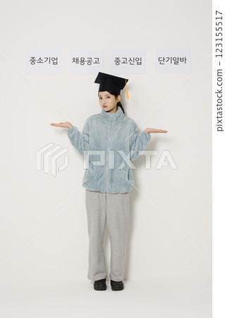 A student wearing a graduation cap and thinking 123155517