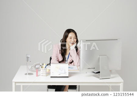 MZ employee in his 20s sitting in front of his office desk 123155544