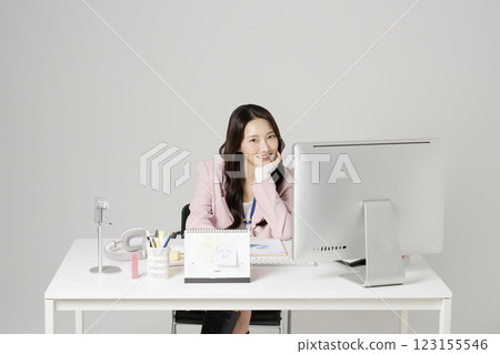 MZ employee in his 20s sitting in front of his office desk 123155546