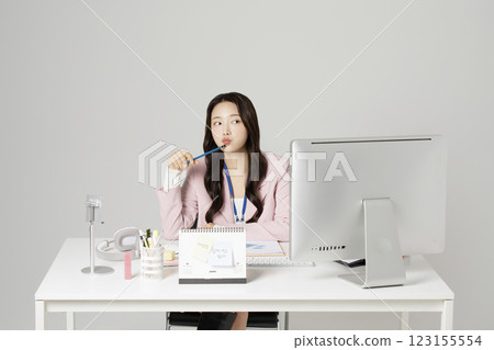 MZ employee in his 20s sitting in front of his office desk 123155554