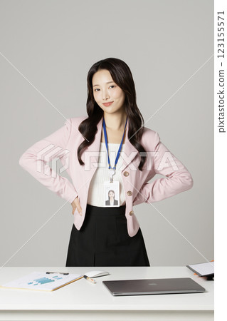 MZ employee in his 20s standing in front of his office desk 123155571