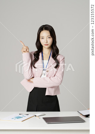 MZ employee in his 20s standing in front of his office desk 123155572